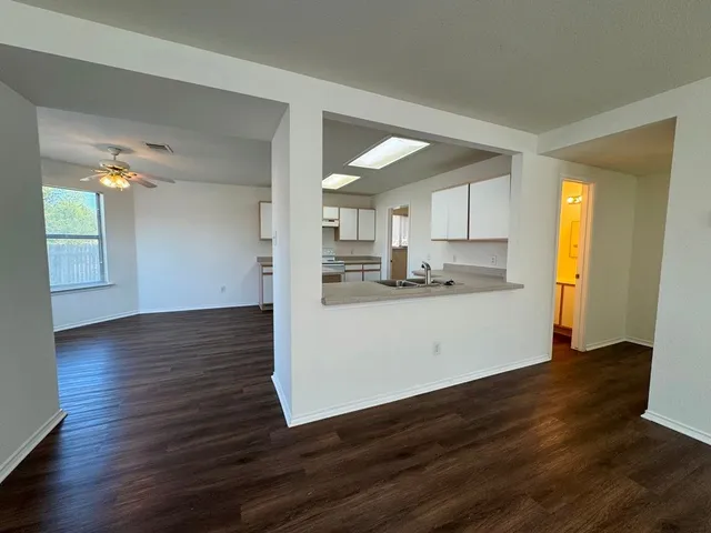 a view of a kitchen with wooden floor