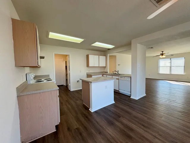 a kitchen with a refrigerator and a stove top oven