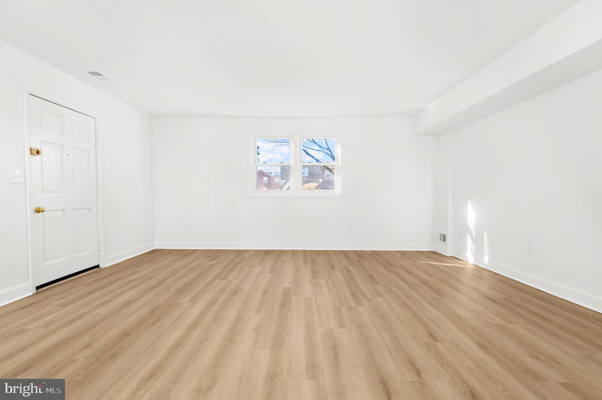 615 Bywater Road Annapolis, MD 21401 - Photo 11 of 28 an empty room with wooden floor and windows