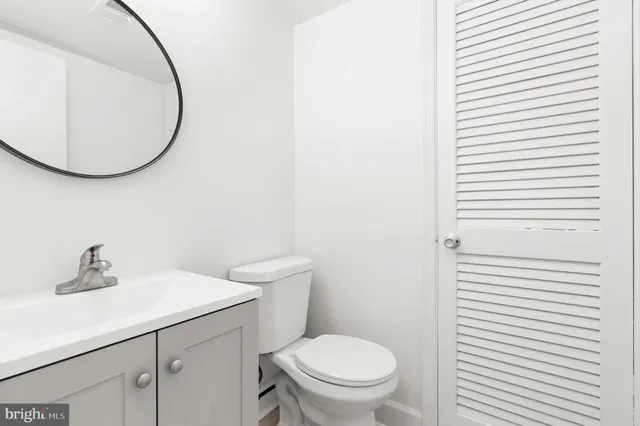 a white toilet sitting next to a bathroom sink