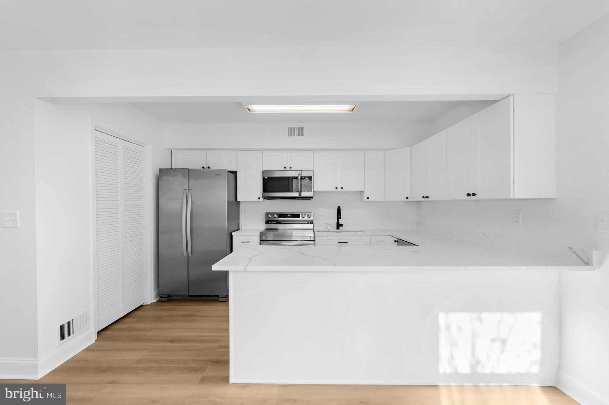 615 Bywater Road Annapolis, MD 21401 - Photo 4 of 28 a kitchen with stainless steel appliances a refrigerator sink and microwave
