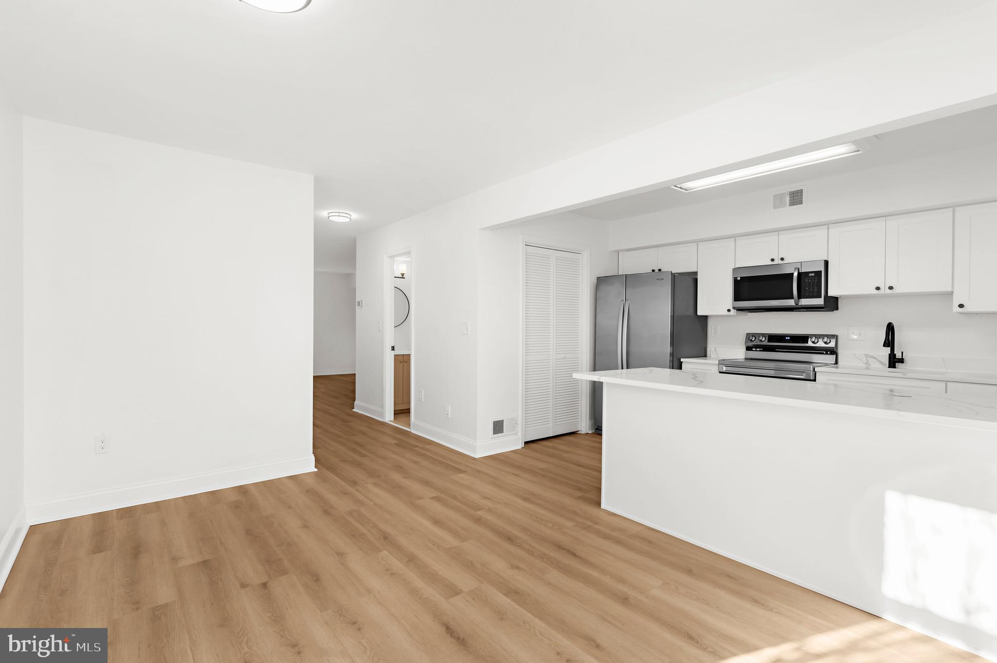 615 Bywater Road Annapolis, MD 21401 - Photo 5 of 28 a view of kitchen with stainless steel appliances wooden floor and living room