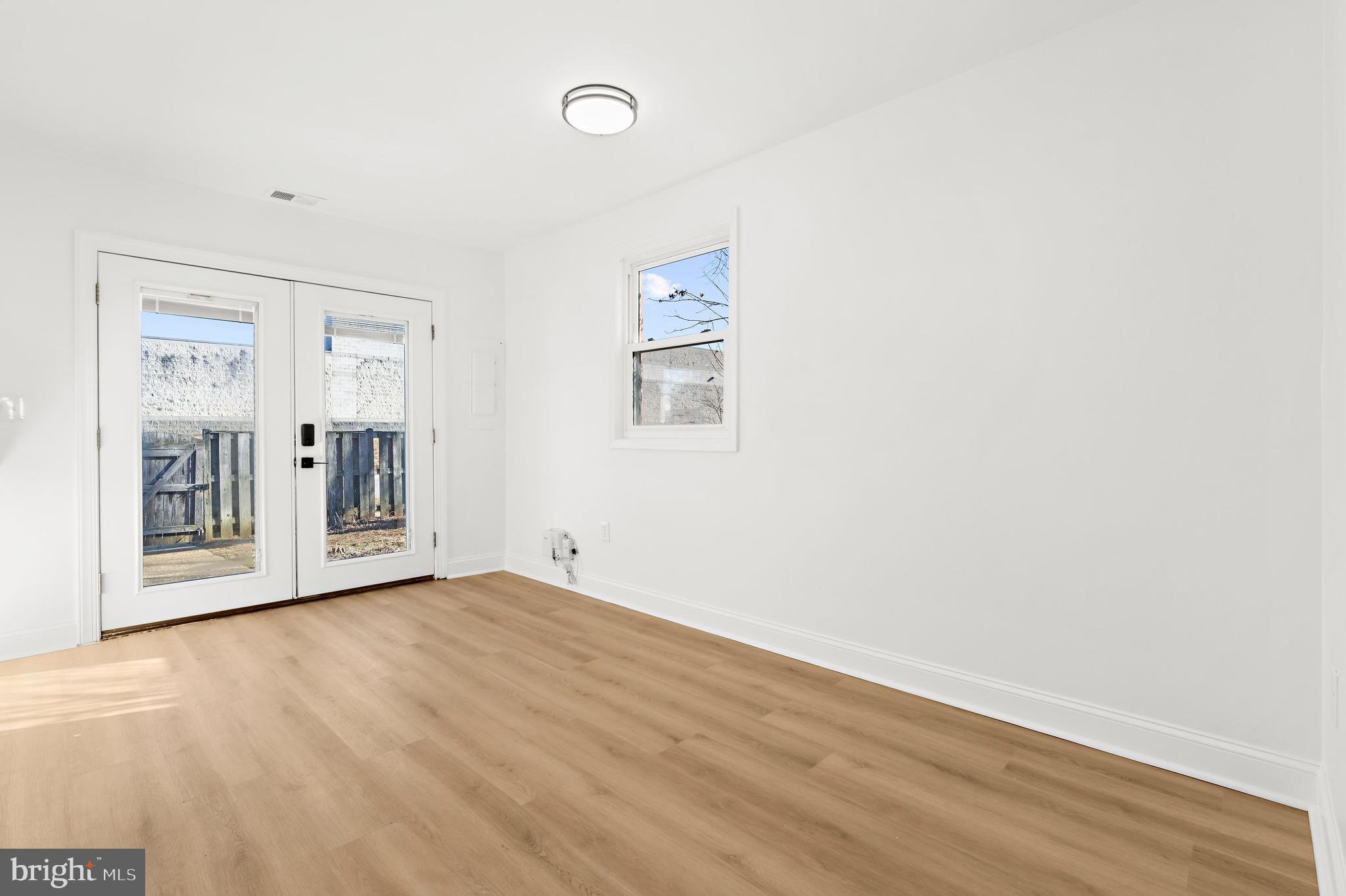 615 Bywater Road Annapolis, MD 21401 - Photo 9 of 28 a view of an empty room with wooden floor and a window