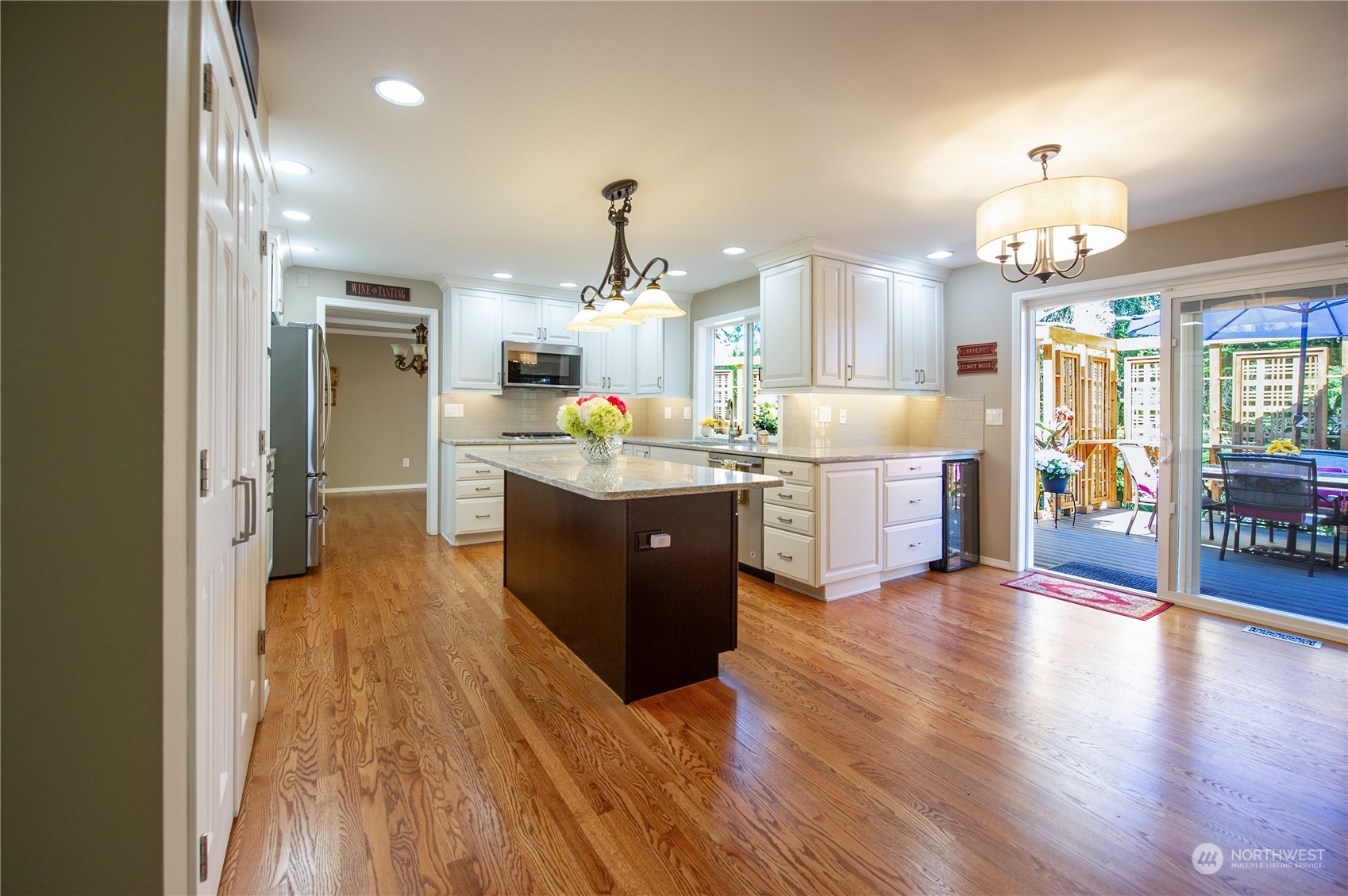 3427 112th Place Southeast Everett, WA 98208 - Photo 3 of 26 a kitchen with stainless steel appliances granite countertop a refrigerator a sink dishwasher a stove and white cabinets with wooden floor