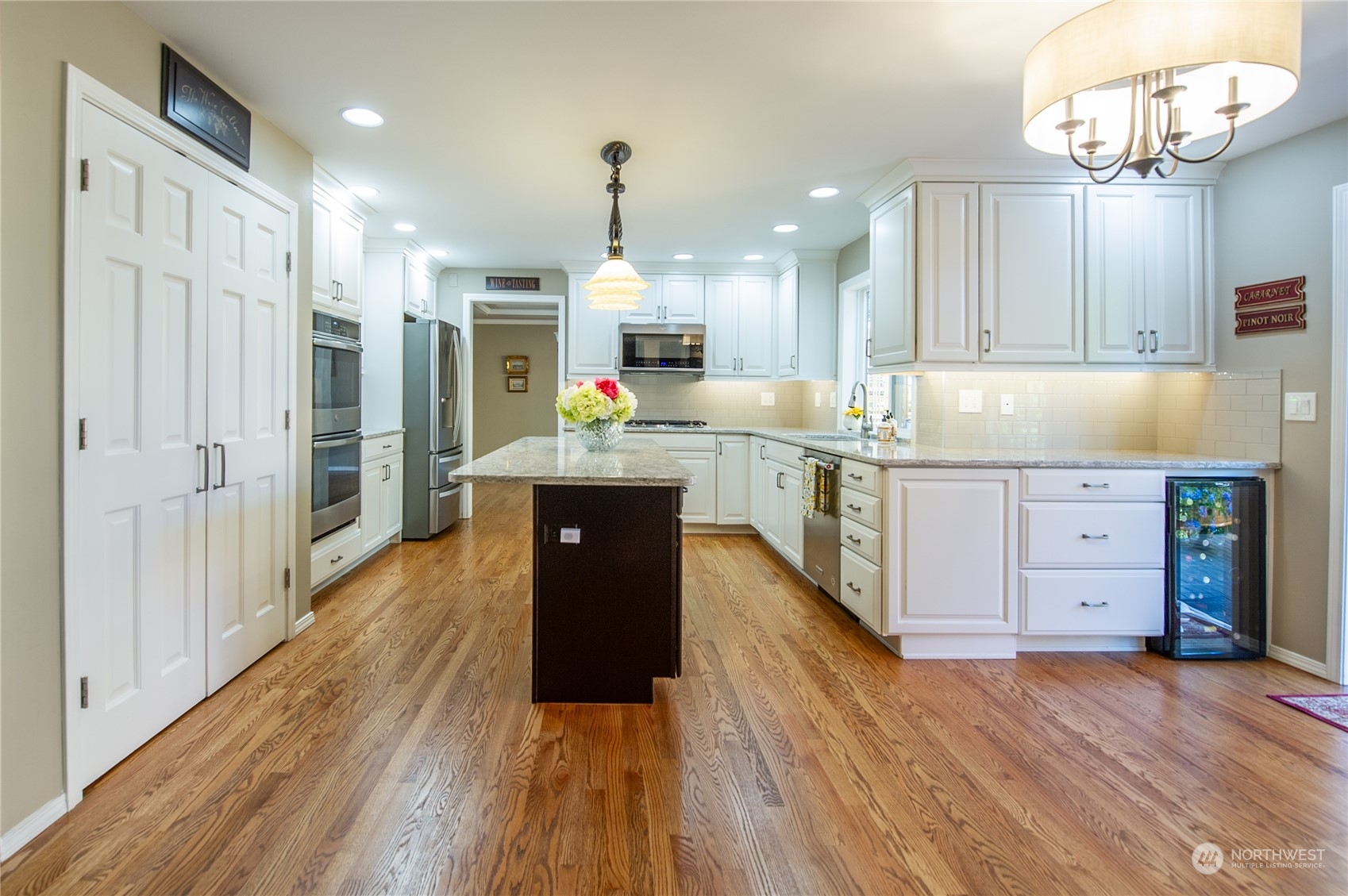 3427 112th Place Southeast Everett, WA 98208 - Photo 7 of 26 a kitchen with kitchen island stainless steel appliances a stove refrigerator and cabinets