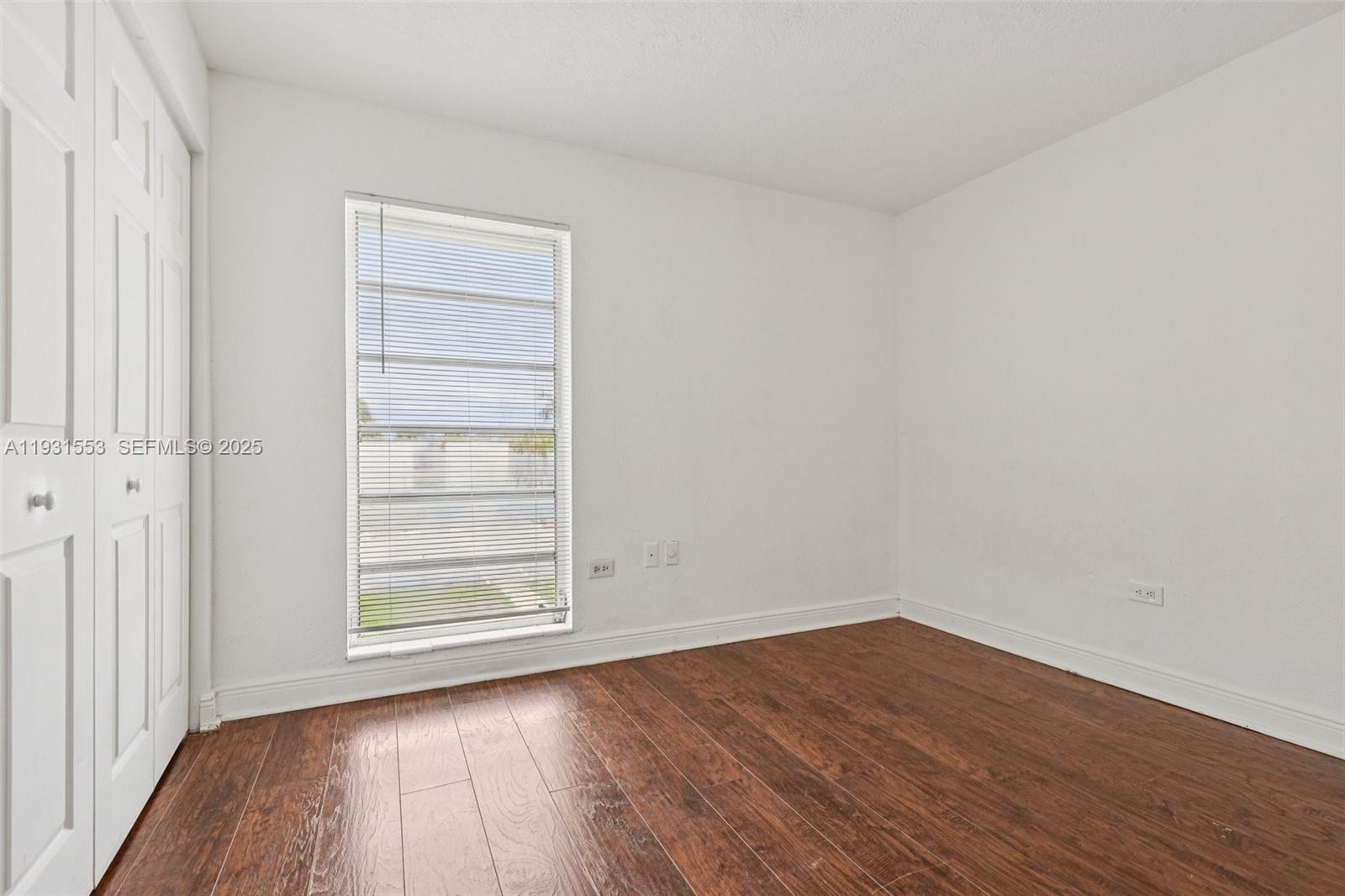 7232 Southwest 94th Place, Unit E6 Miami, FL 33173 - Photo 18 of 31 wooden floor in an empty room