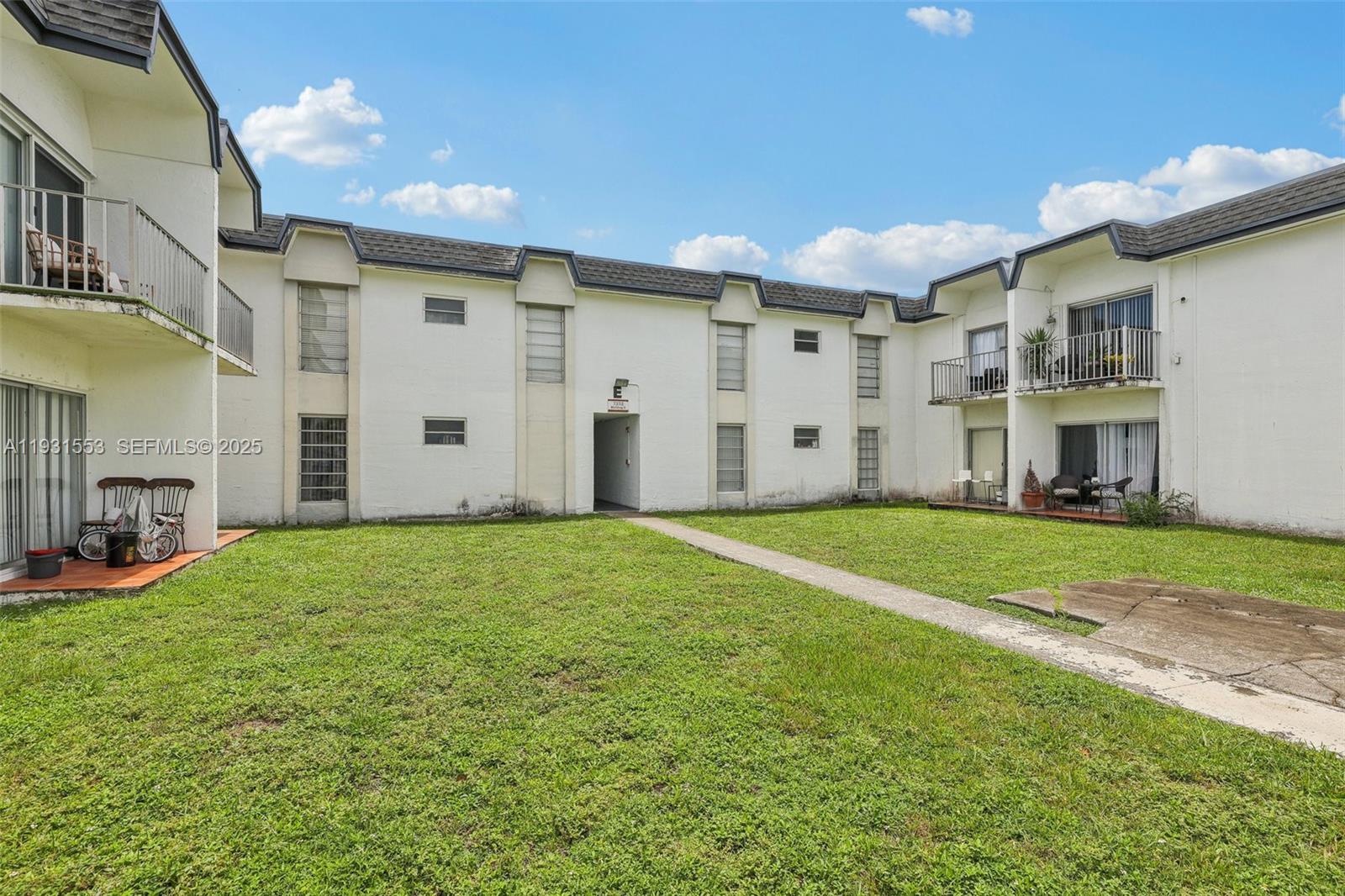 7232 Southwest 94th Place, Unit E6 Miami, FL 33173 - Photo 31 of 31 a house view with a backyard space