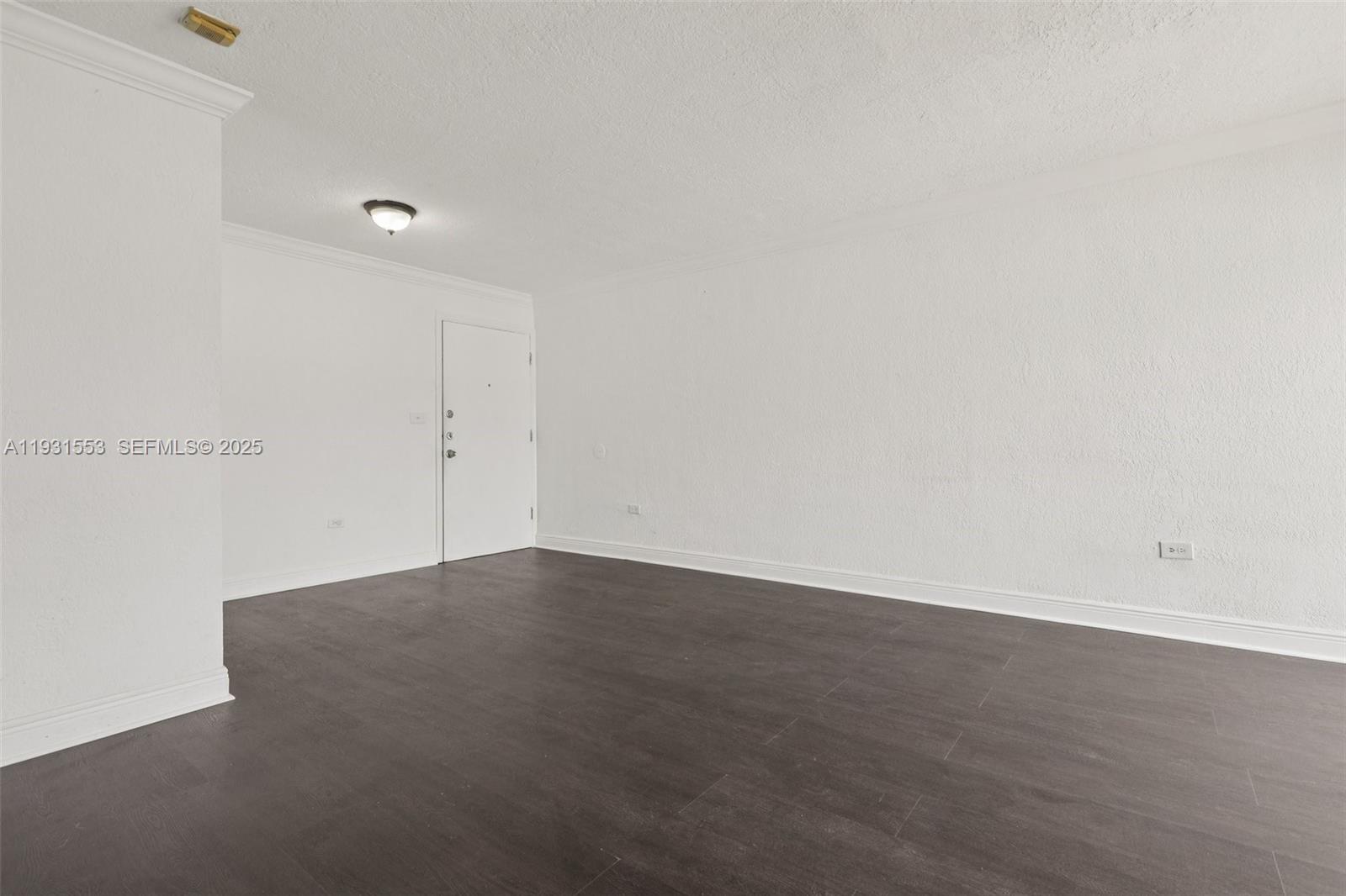 7232 Southwest 94th Place, Unit E6 Miami, FL 33173 - Photo 9 of 31 an empty room with wooden floor