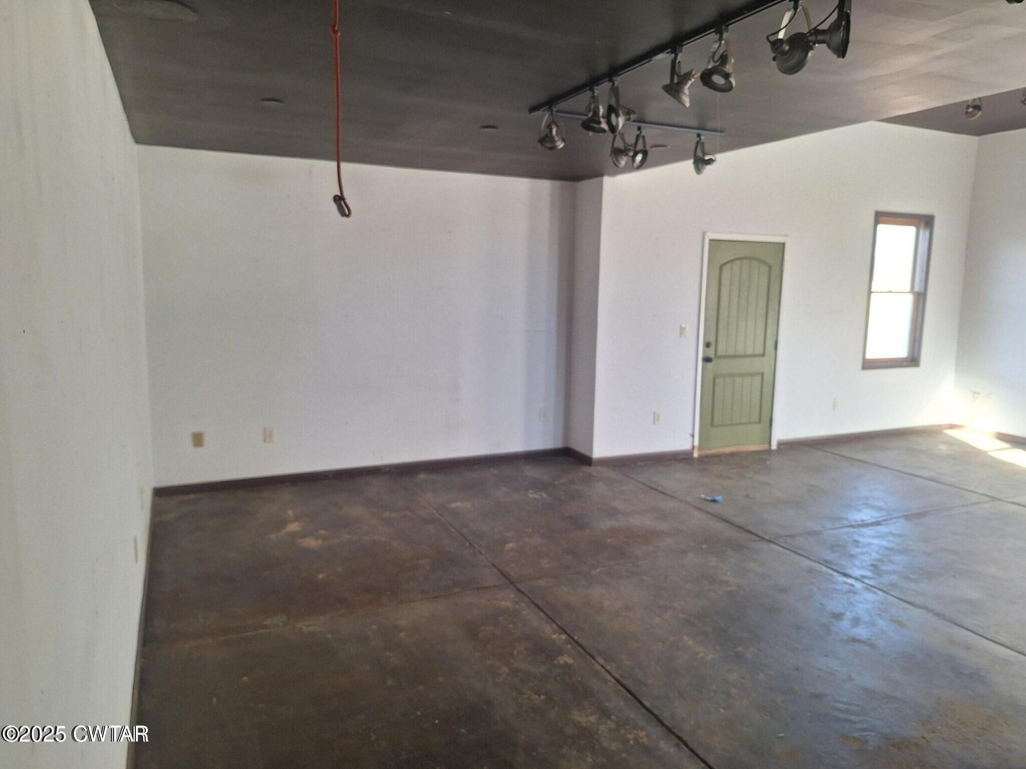 600 Highway 64 Adamsville, TN 38310 - Photo 11 of 25 a view of a big room with wooden floor and windows