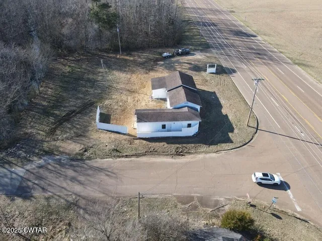 a view of a big room with wooden floor and windows