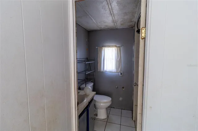 a kitchen with granite countertop a stove and a wooden floors