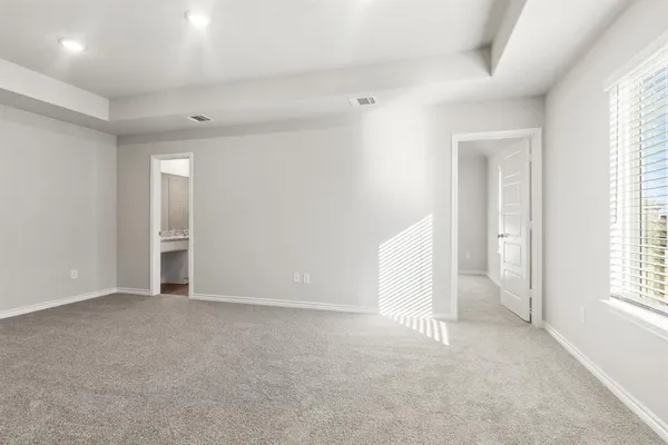 an empty room with windows and closet