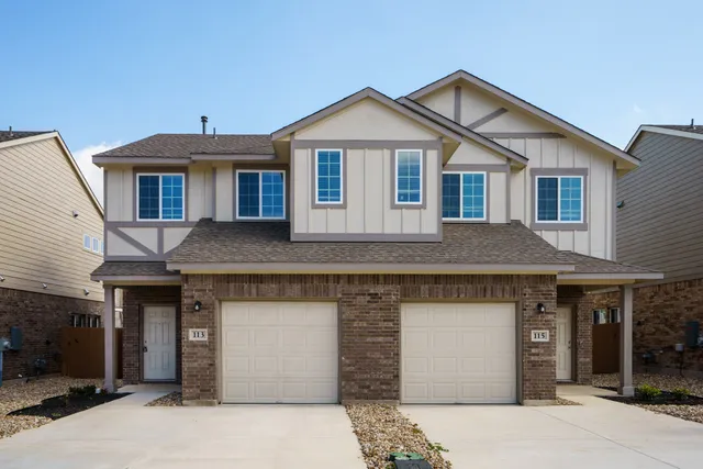 a front view of a house with a garage