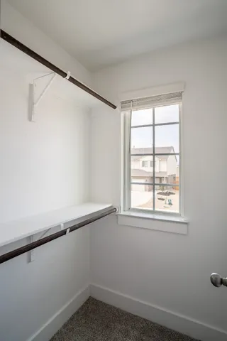 a view of a livingroom with wooden floor and window