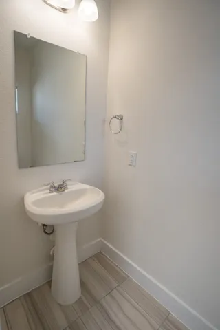 a kitchen with stainless steel appliances a stove a sink and white cabinets