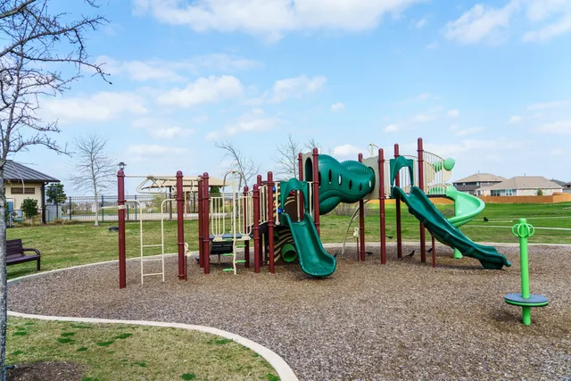 swimming view of a swimming pool with a table and chairs