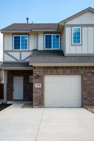 a front view of a house with garage