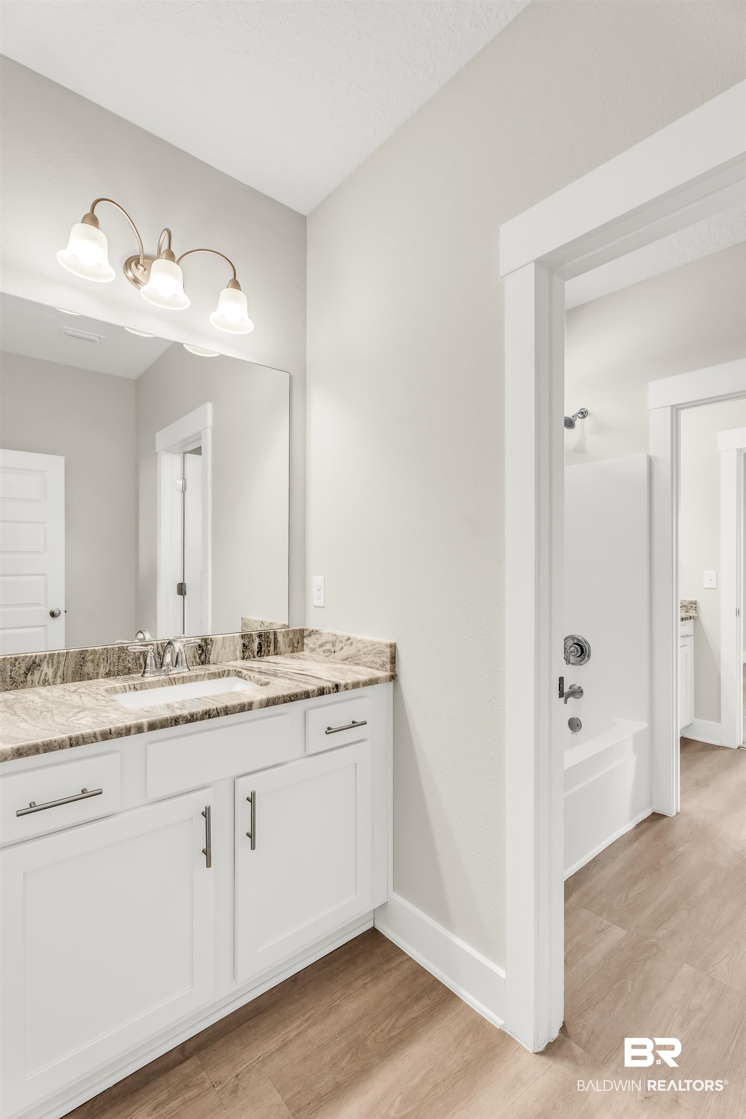 1720 Partridge Street Foley, AL 36535 - Photo 24 of 32 Bathroom with washtub / shower combination, vanity, and hardwood / wood-style floors