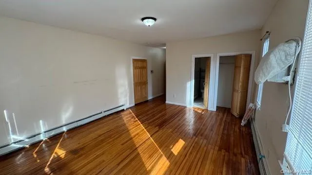 a view of a room with wooden floor