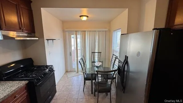 a kitchen with a table and chairs