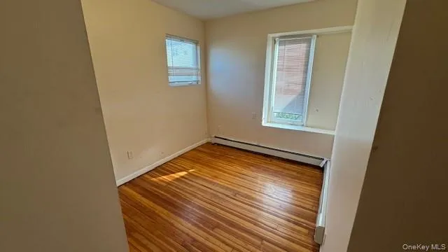 a view of a room with wooden floor and window