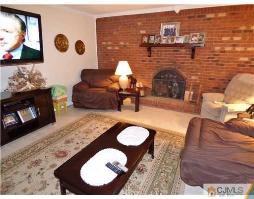 12 Sherwood Road Edison, NJ 08820 - Photo 11 of 23 a living room with furniture and a fireplace