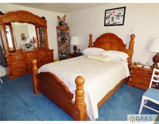 12 Sherwood Road Edison, NJ 08820 - Photo 16 of 23 a bed room with a bed and a chair