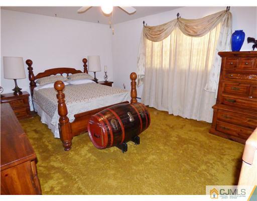12 Sherwood Road Edison, NJ 08820 - Photo 19 of 23 a bedroom with a bed and a painting on the wall