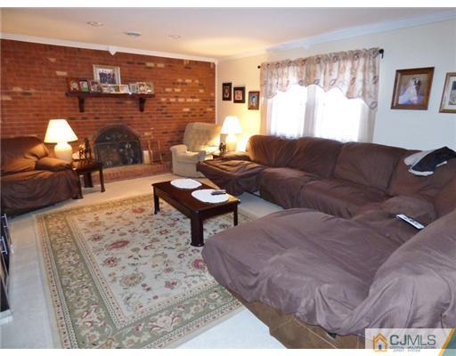 12 Sherwood Road Edison, NJ 08820 - Photo 5 of 23 a living room with furniture and a fireplace
