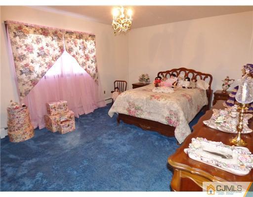 12 Sherwood Road Edison, NJ 08820 - Photo 7 of 23 a bedroom with a bed and a window