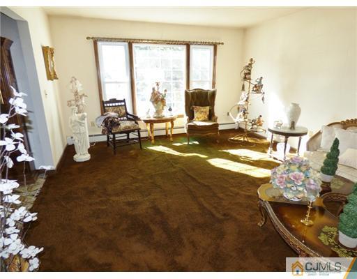 12 Sherwood Road Edison, NJ 08820 - Photo 9 of 23 a living room with furniture and a large window