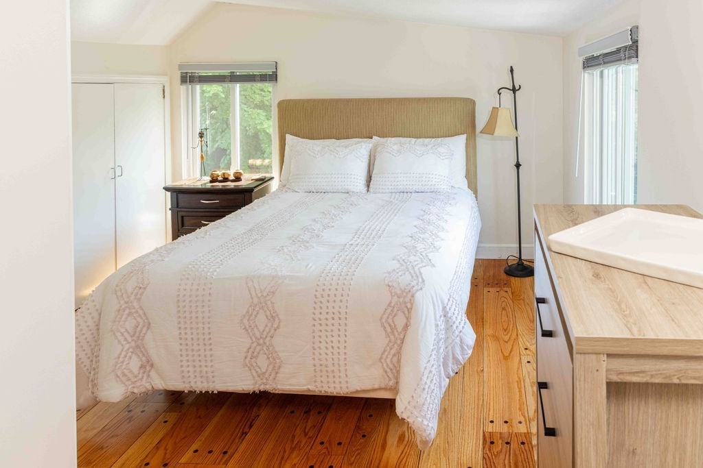 85 Pitman Road Marblehead, MA 01945 - Photo 18 of 27 a bedroom with a bed and wooden floor