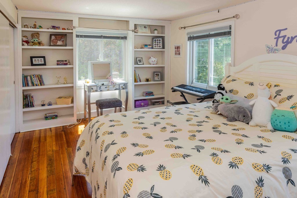 85 Pitman Road Marblehead, MA 01945 - Photo 20 of 27 a bedroom with a bed and a book shelf