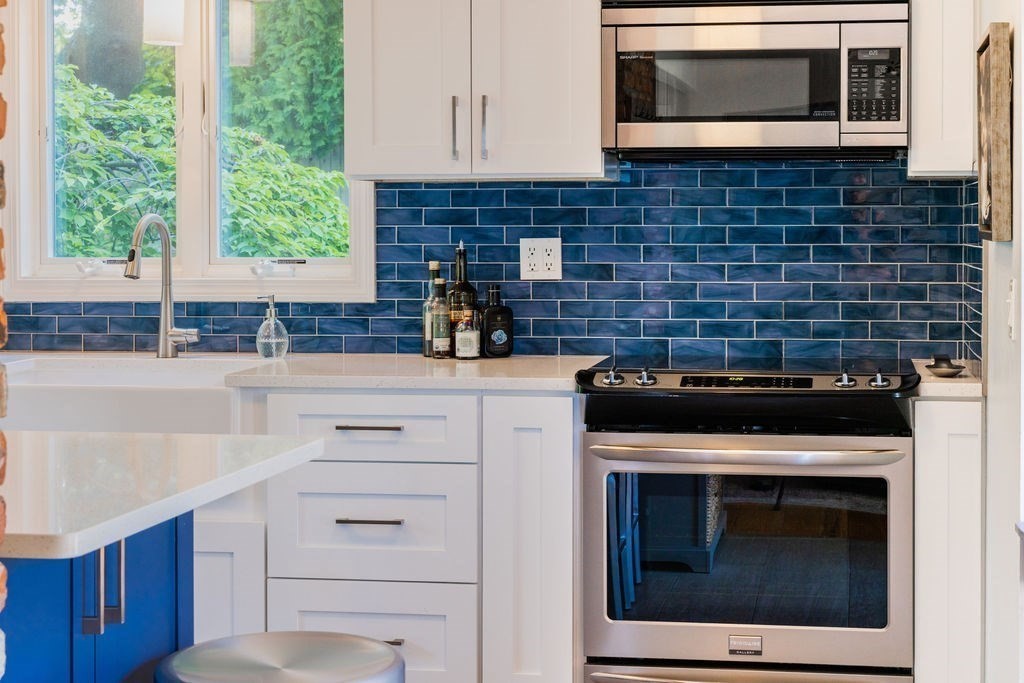 85 Pitman Road Marblehead, MA 01945 - Photo 9 of 27 a kitchen with stainless steel appliances white cabinets and a stove top oven
