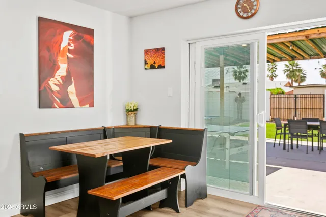 a dining room with furniture and a floor to ceiling window