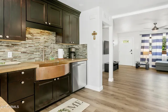 a kitchen with stainless steel appliances granite countertop a sink stove and cabinets