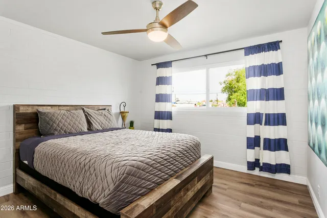 a bedroom with a bed and a potted plant