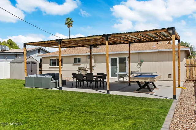 a view of a house with a yard chairs and furniture