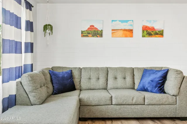 a living room with furniture and painting on the wall