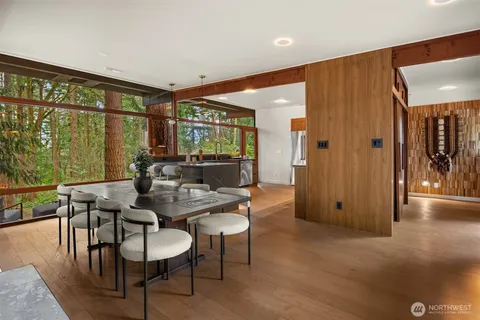 a dining room with furniture and wooden floor