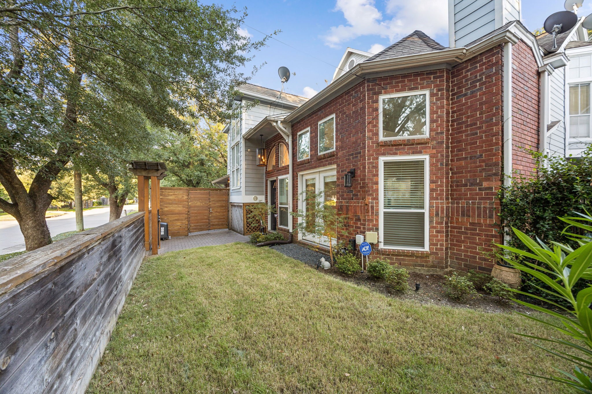 220 East 8th Street Houston, TX 77007 - Photo 26 of 35 a view of a brick house with a large windows and a large tree