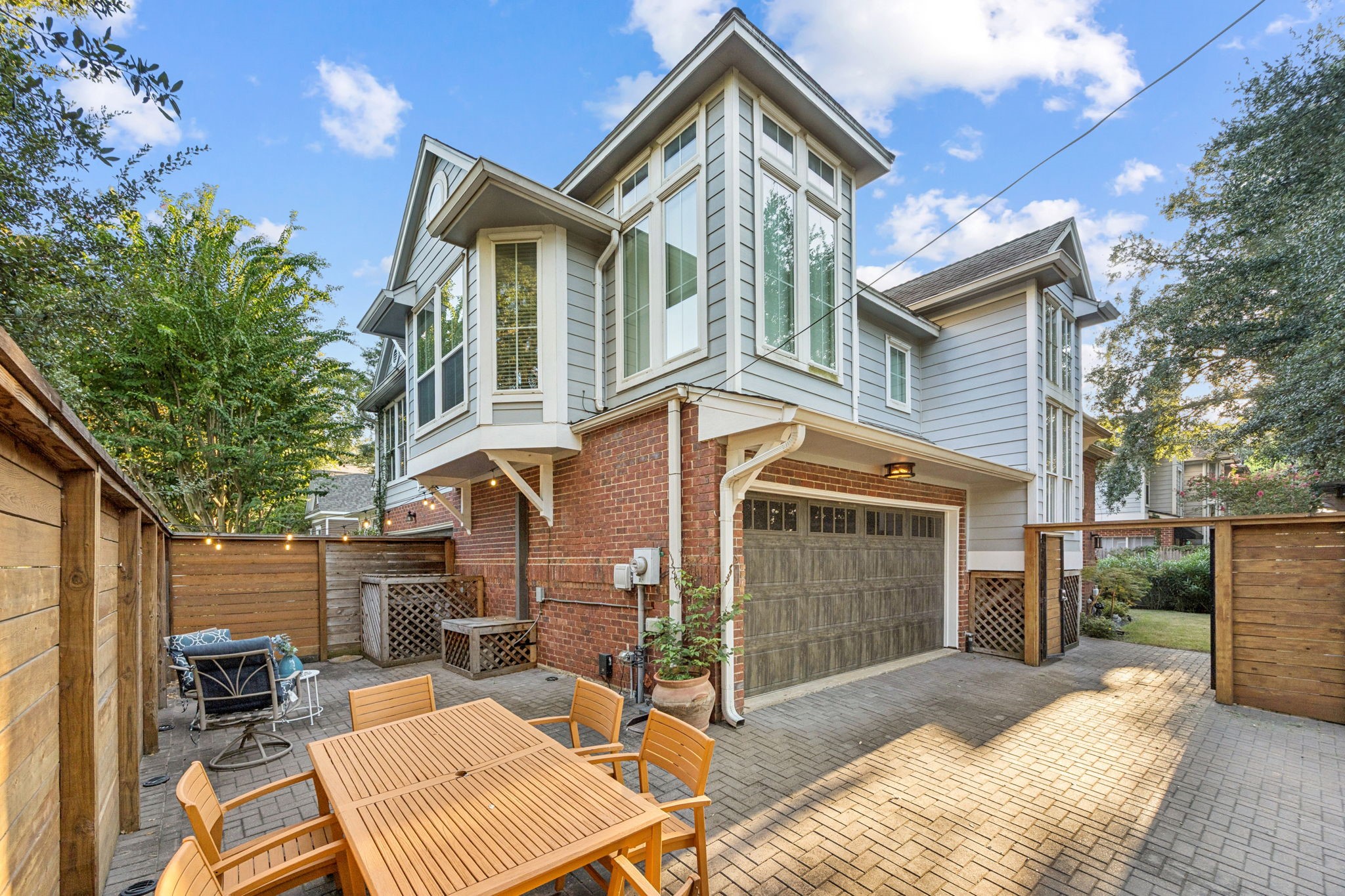 220 East 8th Street Houston, TX 77007 - Photo 4 of 35 a view of a house with a yard and lawn chairs with a fire pit