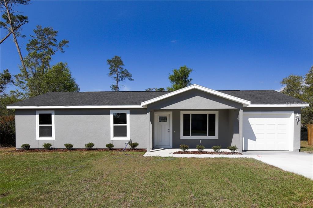 14489 Southwest 42nd Terrace Road Ocala, FL 34473 - Photo 1 of 1 a front view of a house with a yard