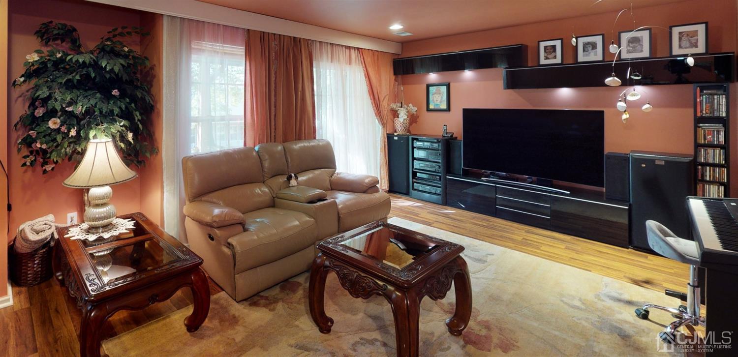 1069 Shadowlawn Drive, Unit 604 Green Brook, NJ 08812 - Photo 17 of 45 a living room with furniture and a flat screen tv