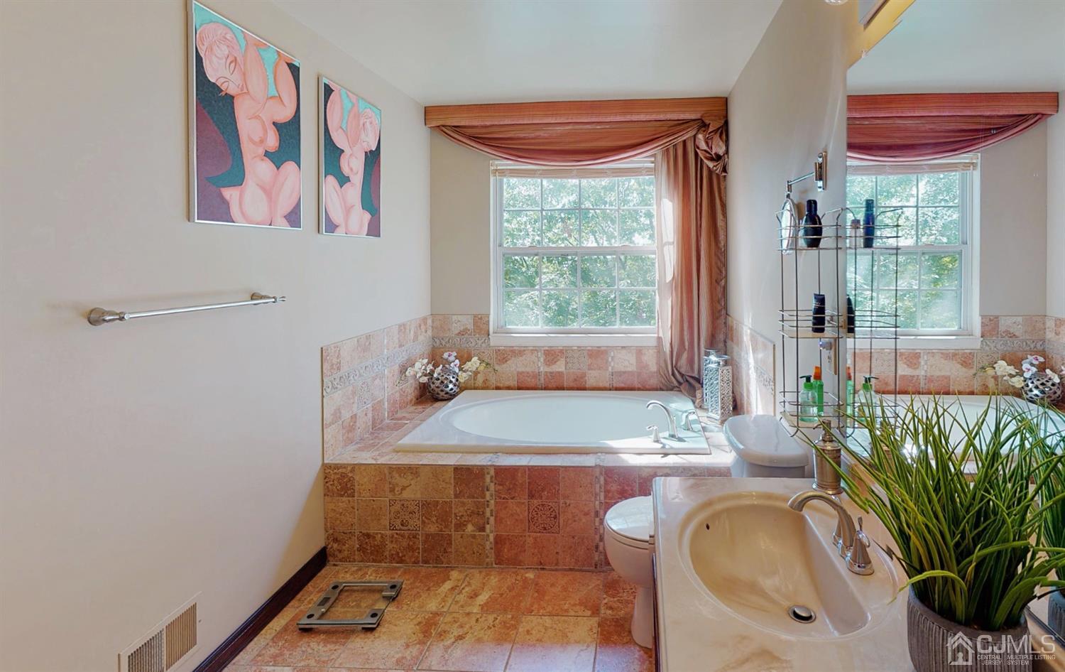 1069 Shadowlawn Drive, Unit 604 Green Brook, NJ 08812 - Photo 24 of 45 a bathroom with a granite countertop sink a toilet and a window