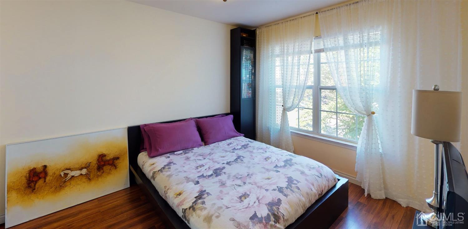1069 Shadowlawn Drive, Unit 604 Green Brook, NJ 08812 - Photo 26 of 45 a bedroom with a bed and wooden floor
