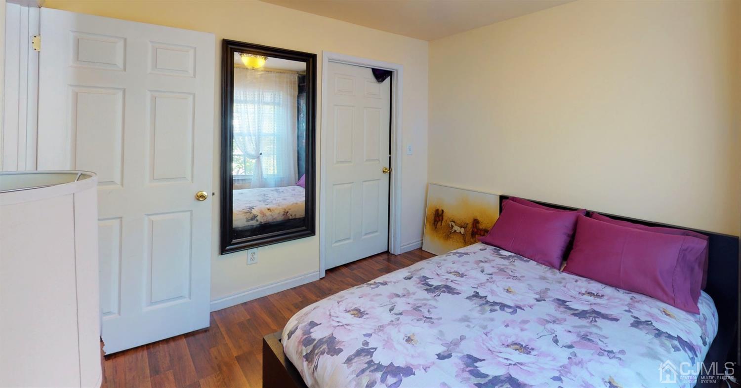 1069 Shadowlawn Drive, Unit 604 Green Brook, NJ 08812 - Photo 28 of 45 a bedroom with a large bed and wooden floor