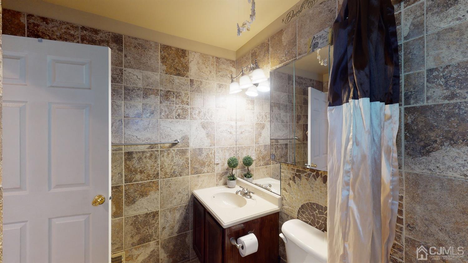 1069 Shadowlawn Drive, Unit 604 Green Brook, NJ 08812 - Photo 29 of 45 a bathroom with a sink mirror and shower