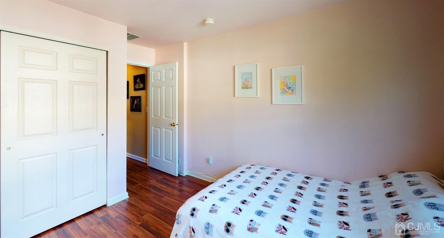 1069 Shadowlawn Drive, Unit 604 Green Brook, NJ 08812 - Photo 35 of 45 a bedroom with a bed and wooden floor