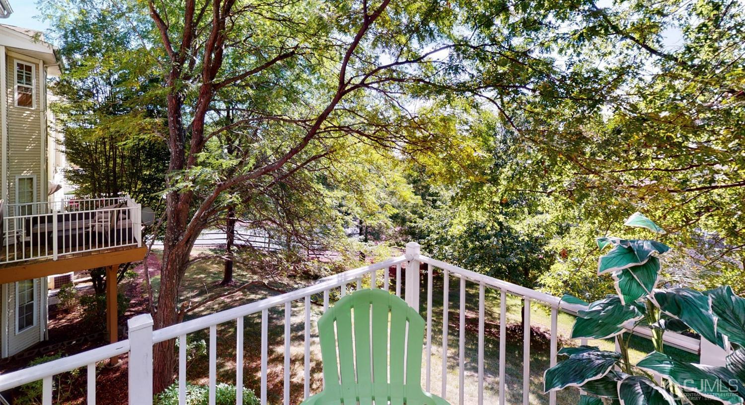 1069 Shadowlawn Drive, Unit 604 Green Brook, NJ 08812 - Photo 36 of 45 a balcony with wooden fence and trees